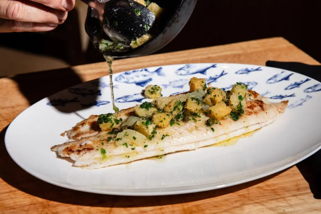 The Dover sole grenobloise is served tableside and adorned with a lemon caper sauce. (Photo by Becca Wright)