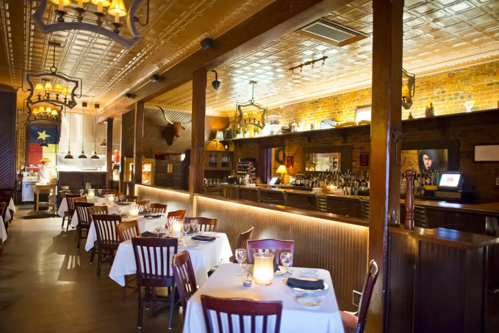 The low-lit dining room at Lonesome Dove makes for a great 25-course menu setting. (Courtesy)