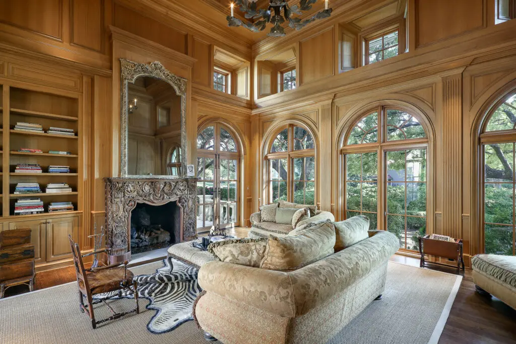 Rooms on the main floor include a library with a hand-carved fireplace. (Photo by Briggs Freeman Sotheby's International Realty)