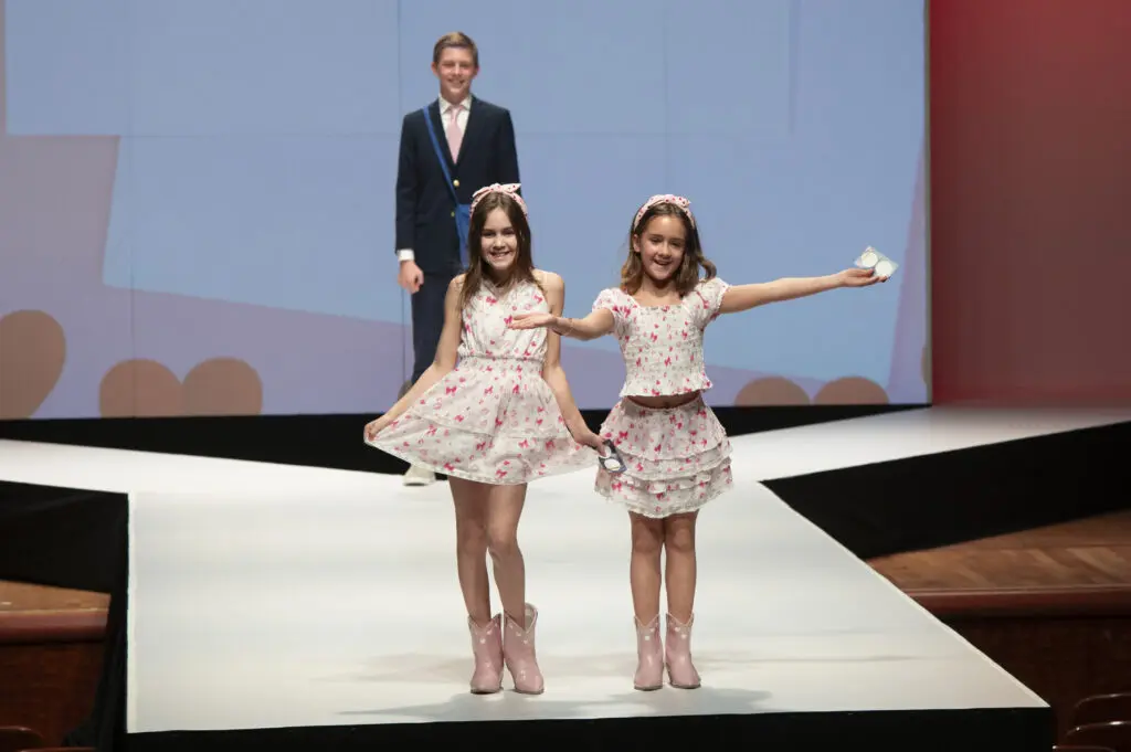 Lucy Price and Ellie Price in LoveShackFancy with mailman Jack Rugg (Photo by Tamytha Cameron)
