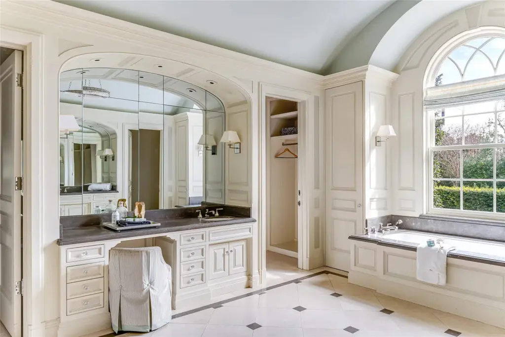 The light-flooded primary bath includes dual vanities and ample space. (Photo by Allie Beth Allman & Associates)