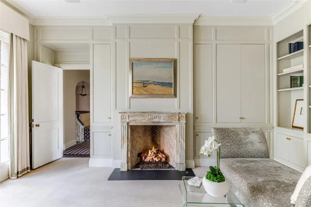 The primary bedroom's sitting area includes a fireplace. (Photo by Allie Beth Allman & Associates)
