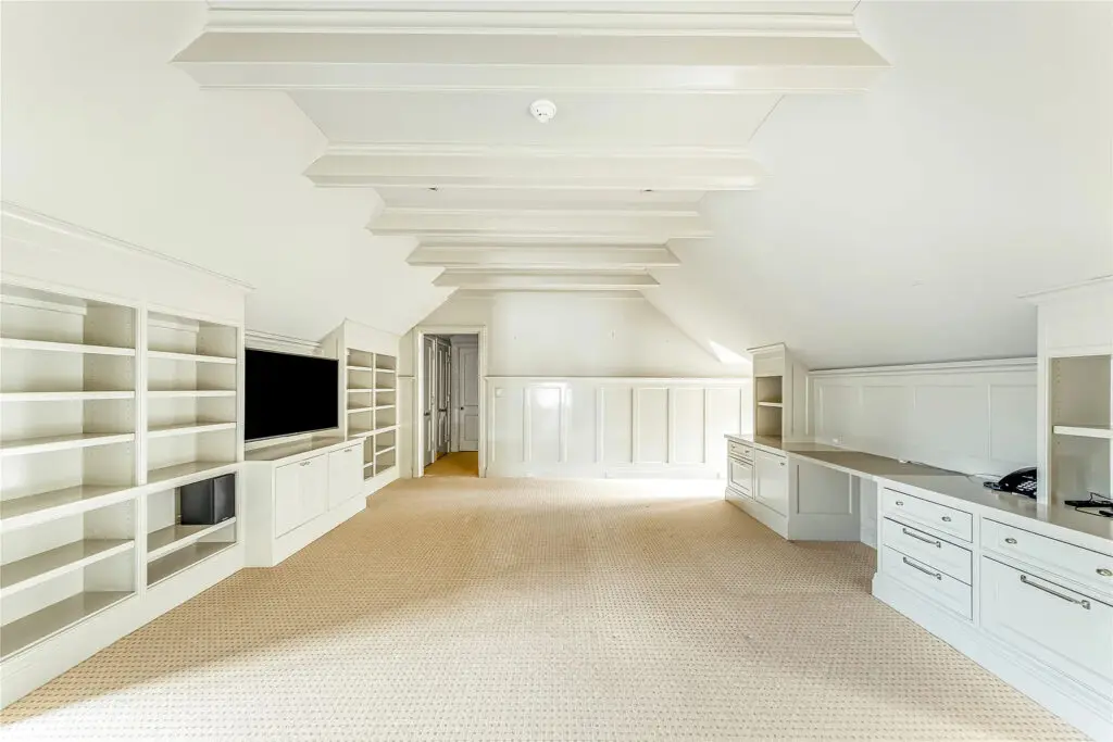 4226 Arcady Avenue's third level serves as a versatile retreat and includes a lounge area, game room, bathroom, and a large storage space. (Photo by Allie Beth Allman & Associates)