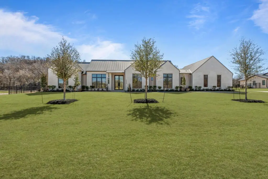 Clean lines, a metal roof, and expansive windows give 9825 Loire Valley Trail a soft contemporary edge within the gates of Montrachet. (Courtesy)