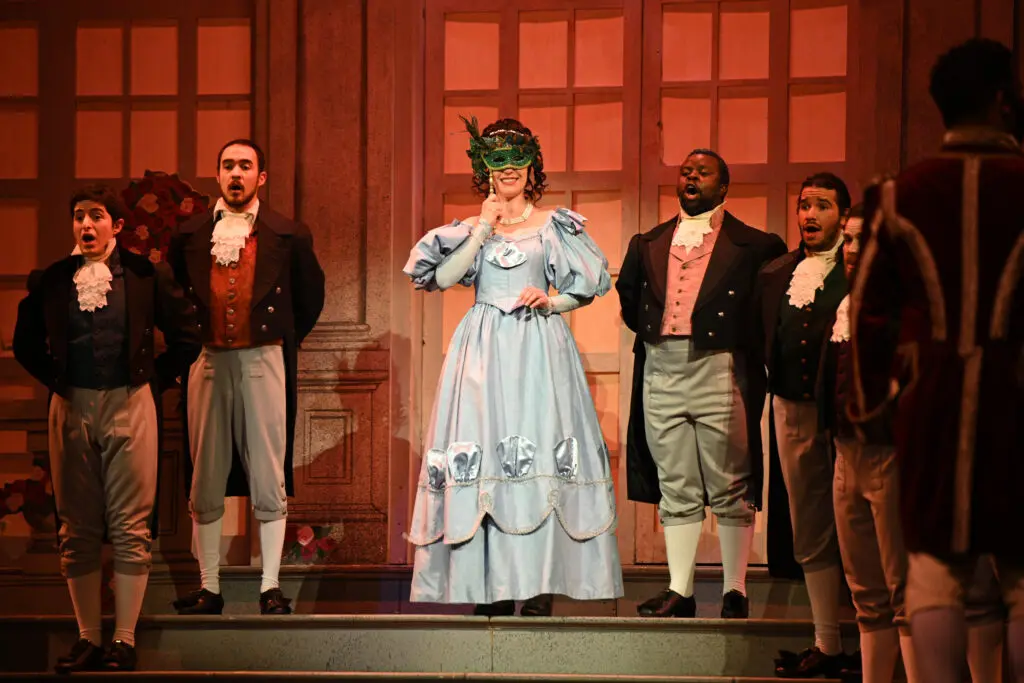 Cinderella reveals herself behind a mask at the ball. (Photo by Fort Worth Opera)