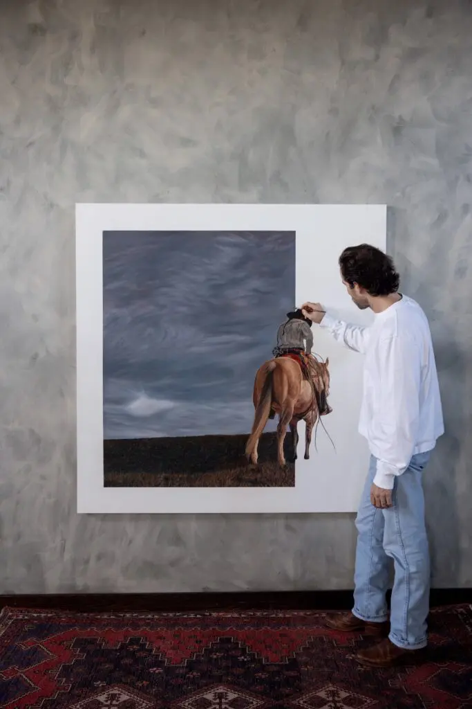 Lovett adds details to his piece. (Photo by Gallery at Bowie House)