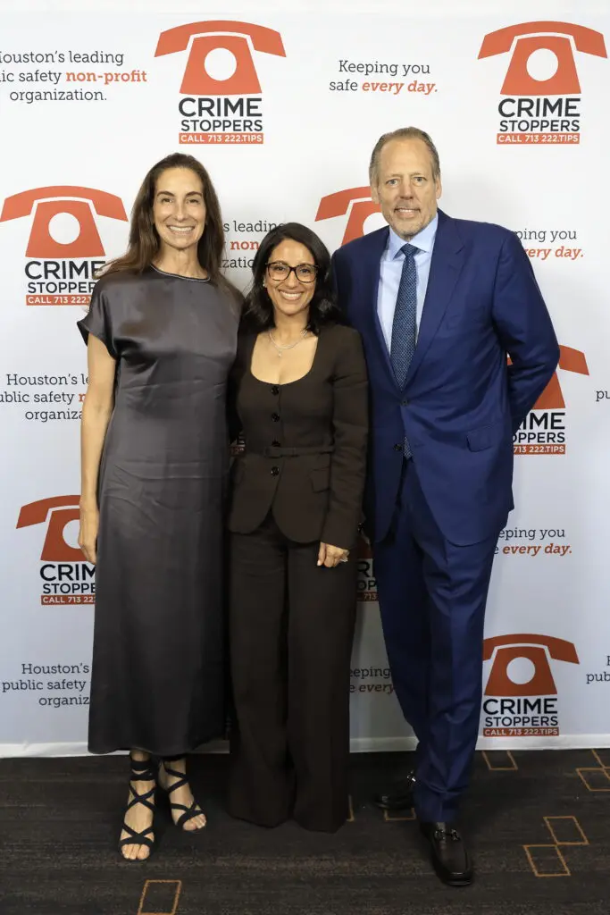 Honorees Lisa & Michael Holthouse, with Rania Mankarious, center, at Crime Stoppers of Houston's 'Houston Heroes' award luncheon.  (Photo by Quy Tran)