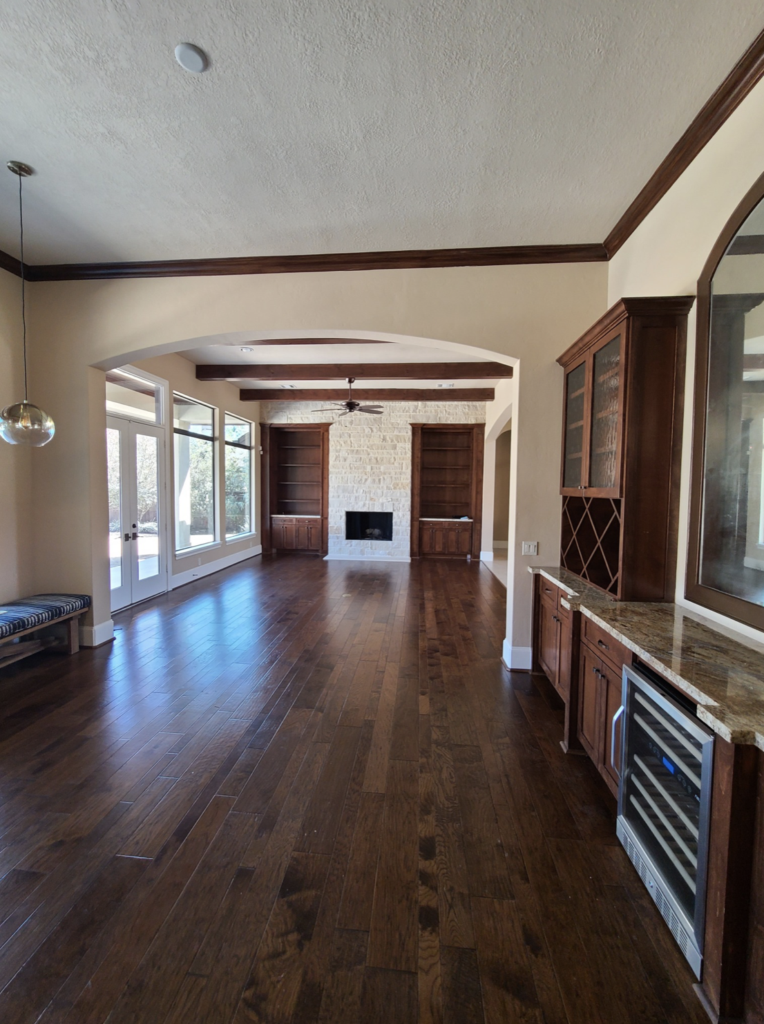 Dark wood and heavy stone were replaced with light floors and a refreshed fireplace area. (Photo by Charbonneau Interiors)