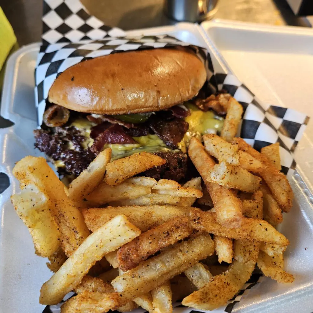 Outside HopFusion, MonkeyShines serves a no-frills burger built from brisket, rib, and chuck with house sauce, pickles, and jalapeños. (Photo by Edward Brown)