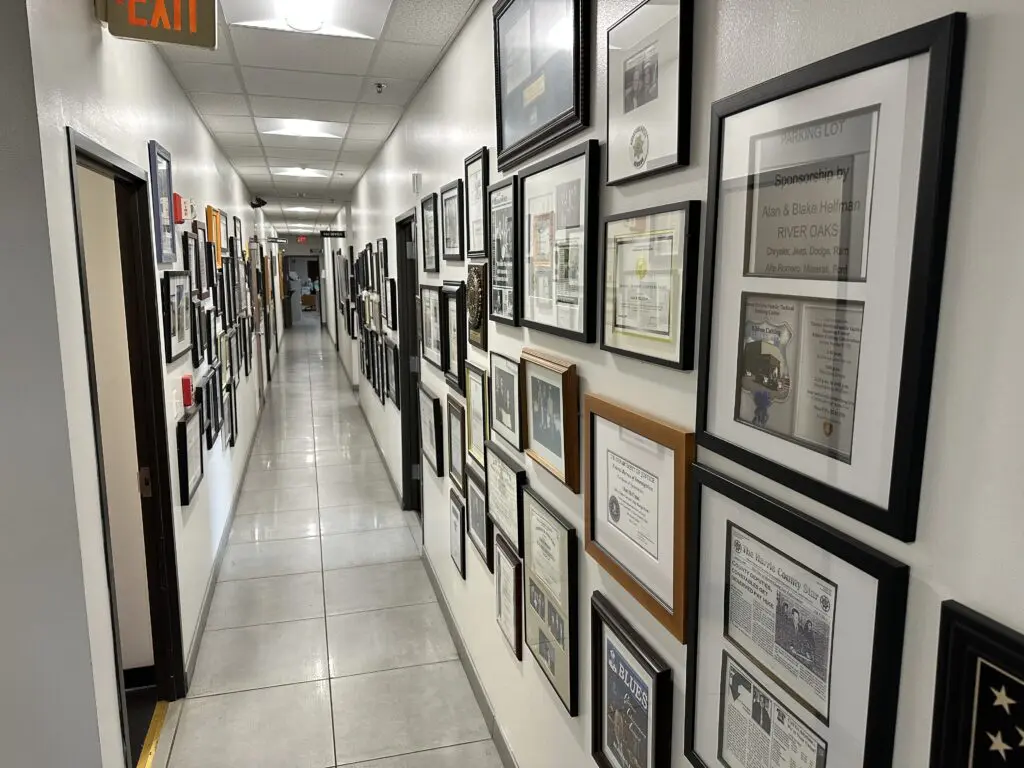 Alan Helfman's office hallways are decorated with plaques from organizations and nonprofits that have benefited from his generosity.