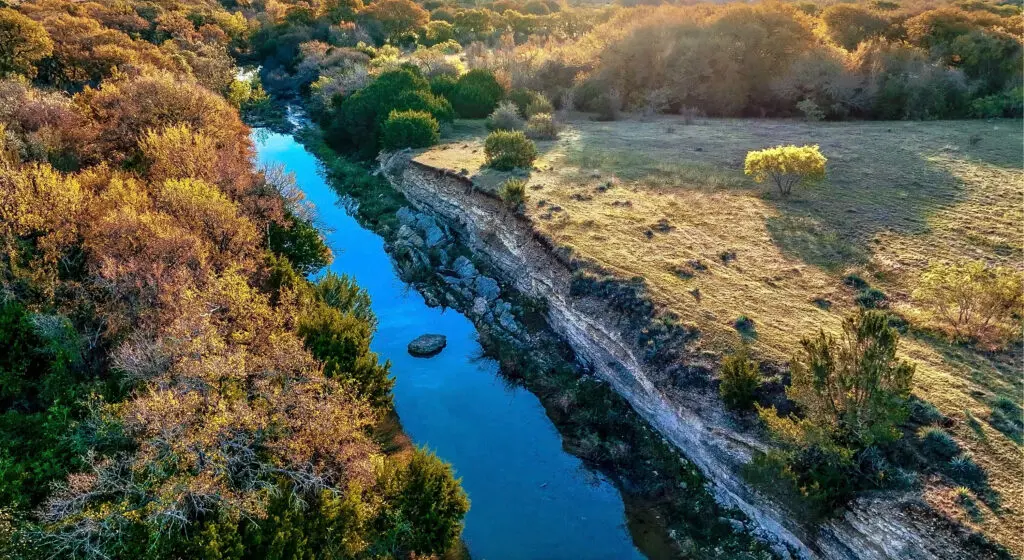 A quiet river winds along the edge of the Bluejack Ranch property, adding to the natural beauty and secluded feel of the Aledo landscape. (Photo by Bluejack Ranch)