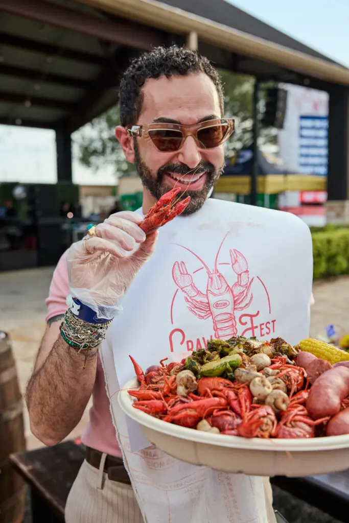 Fady Armanious digging into crawfish at the 13th annual CrawFest (Photo by courtesy of Cotton Holdings)