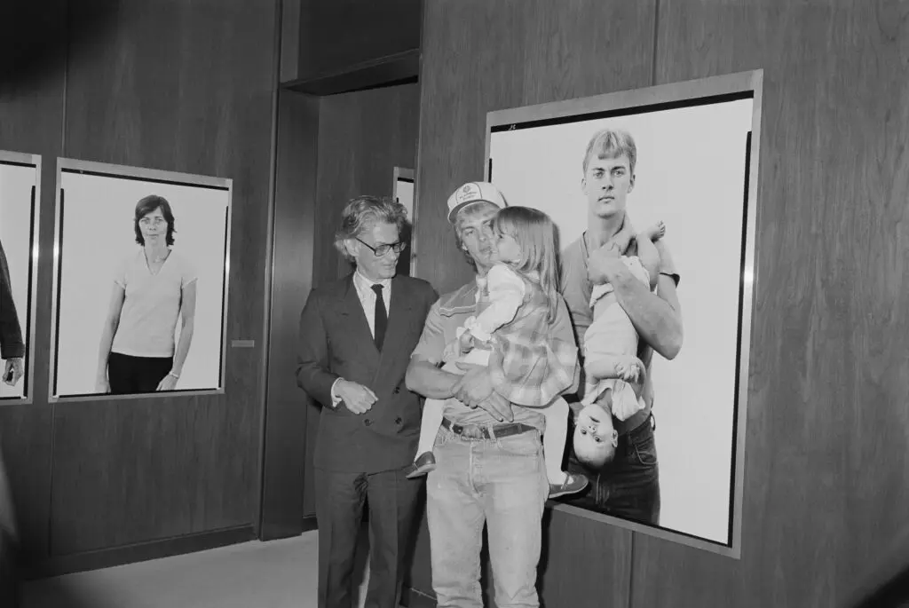 A man stands next to his portrait at the opening of the exhibition 40 years ago.  (Photo by Amon Carter Museum of American Art, Fort Worth, Texas)