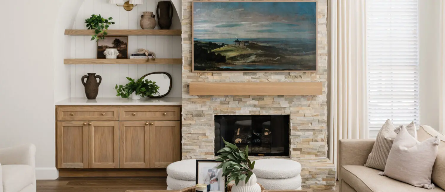 The fireplace serves as the focal point of the family room in this Cochran Crossing's home, with the television now centered above and custom shelving styled for warmth. (Photo by Madeleine Harper)