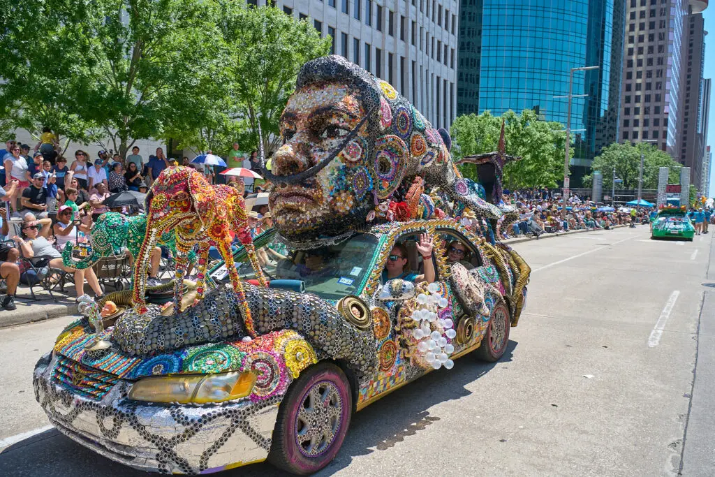 Kerrianne Clabaugh and Wendy Bejerano of the Sam Houston Math, Science, Tech HS Visual Arts Team's "Something to Dream About" at The Orange Show 38th Annual Art Car Parade (Photo by Charlie Ewing)