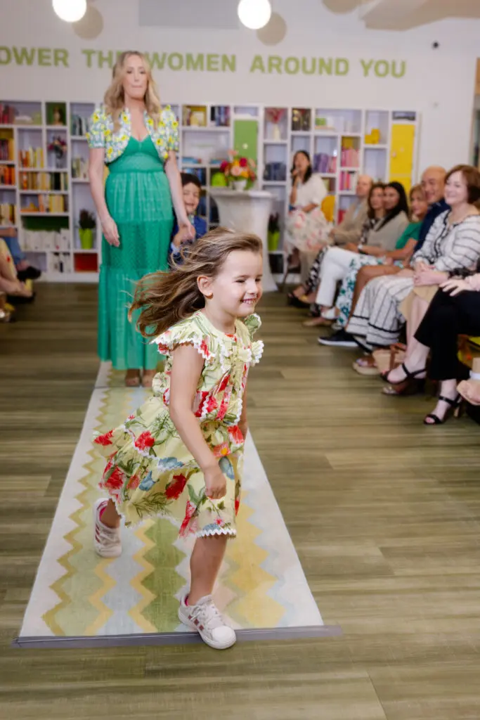 Weezie Lawson make a run for her grandmother leaving mom, Whitney Kuhn Lawson, behind on the runway  at the SheSpace 'Mommy & Me' fashion show (Photo by @LaurenHolubPhotography)