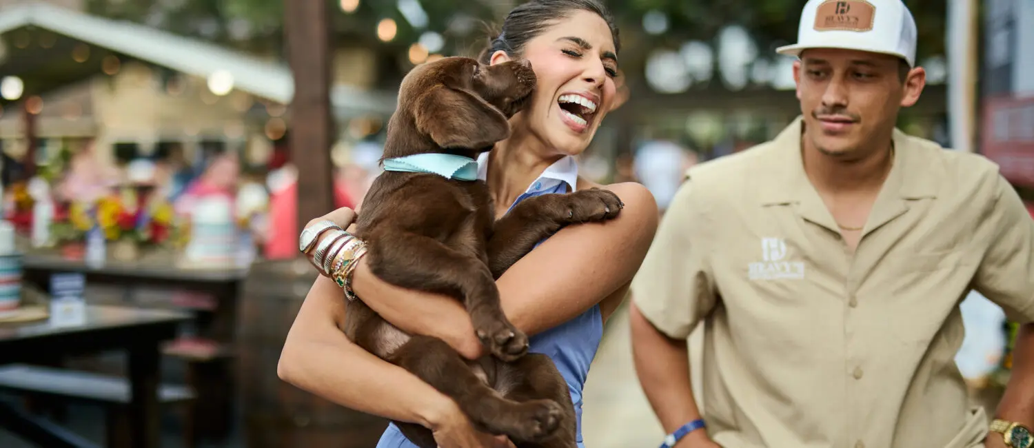 Zinat Ahmed with the chocolate labrador puppy, which she brought into her family after CrawFest; photo courtesy of Cotton Holdings, Inc. (Photo by courtesy of Cotton Holdings)