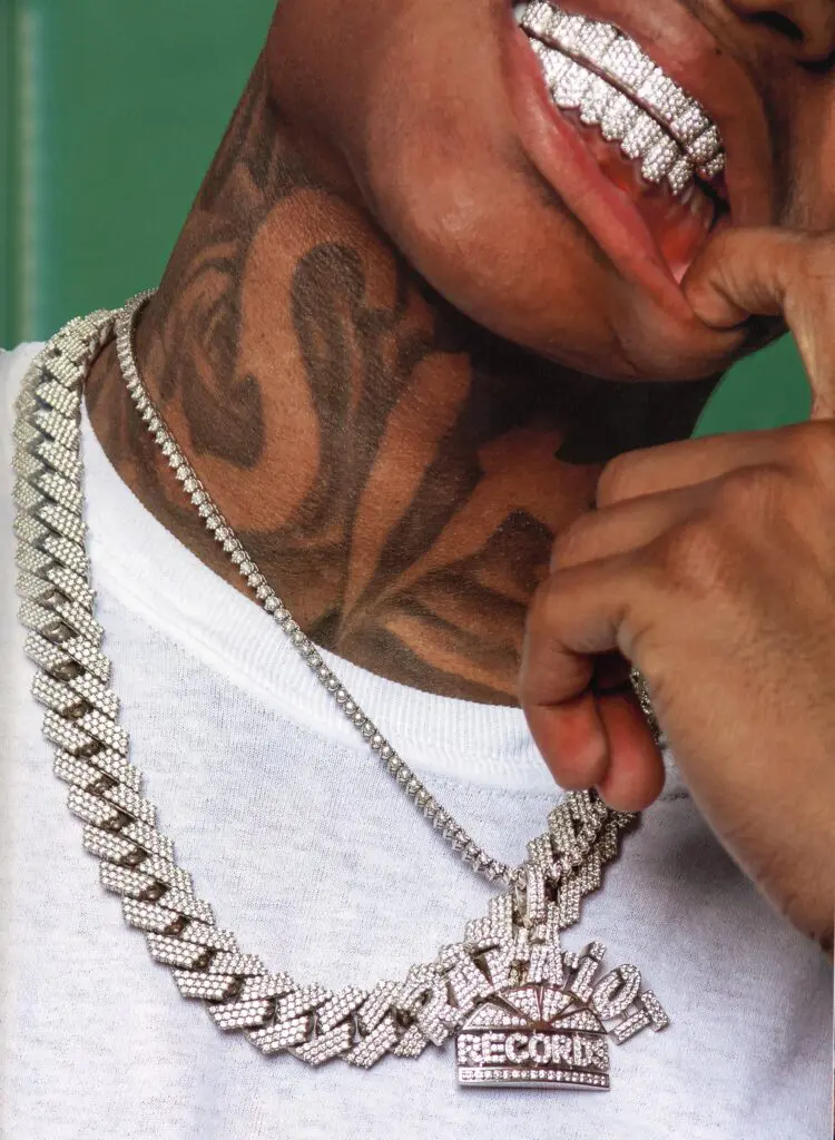 Almighty Jay in Rap-A-Lot label chain on diamond tennis chain, diamond grillz, 2020 (From "Ice Cold: A Hip-Hop Jewelry History" by Vikki Tobak, Taschen, © 2022. Photo by Cheryl Fox)