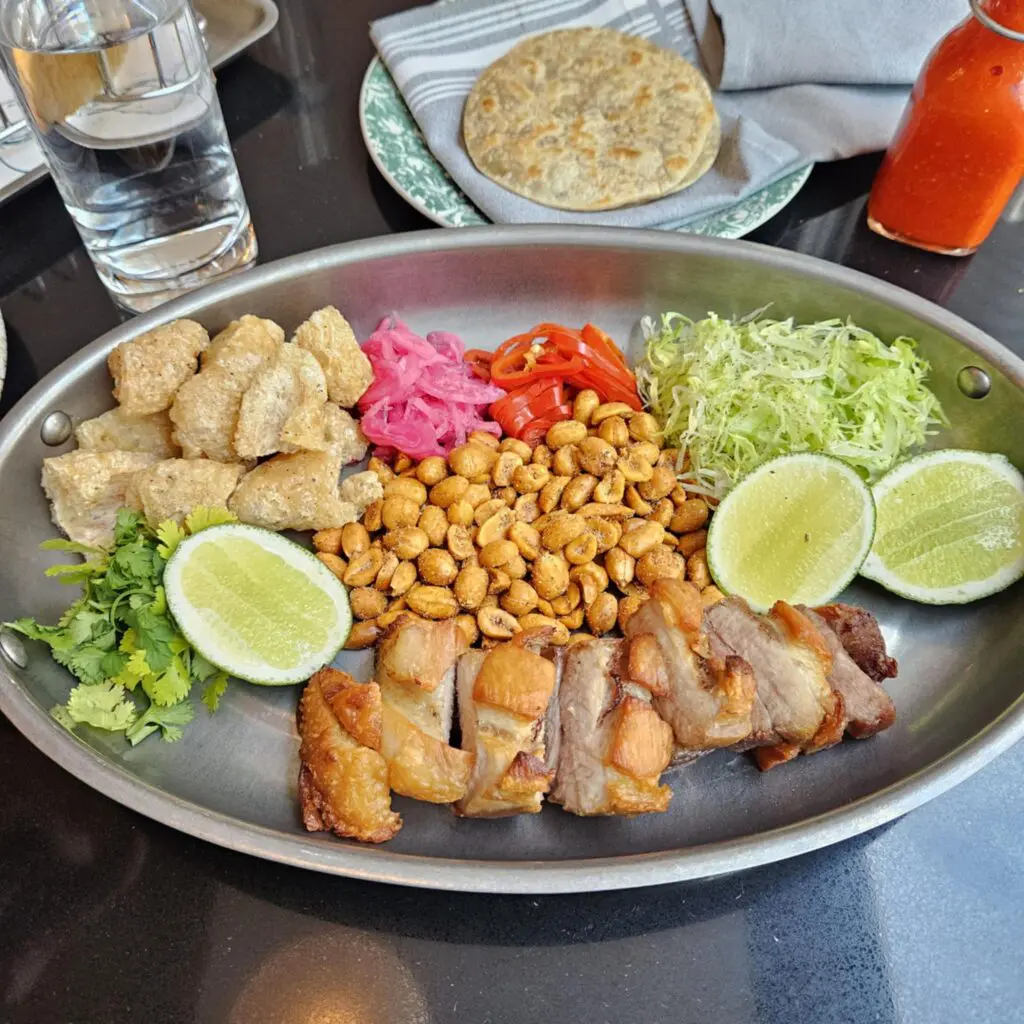 The Lucky Pig at Duchess invites diners to build their own tacos with salt-brined pork belly, crispy chicharrón, and bold, housemade toppings. (Photo by Edward Brown)