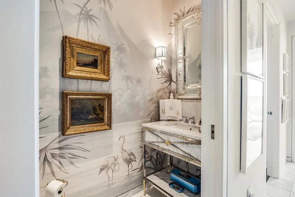The home includes feminine touches, like the Phillip Jefferies' wallcoverings and the jewel box of a powder bath. (Photo by Compass RE Texas)