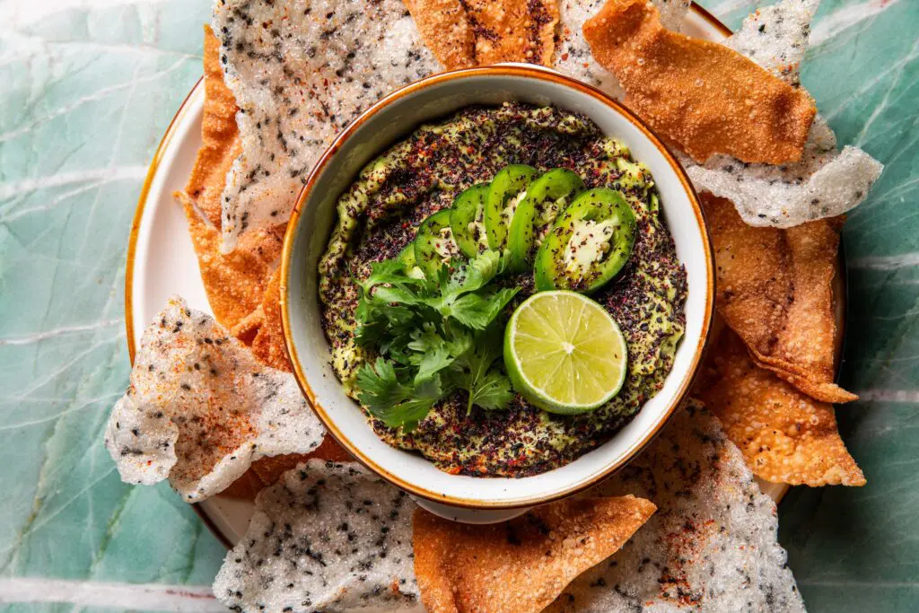sesame guac made with a splash of soy sauce and sesame oil before it’s topped with a crunchy combo of fried shiso crunch served with fried wonton and rice chips ($11) (Photo by Photos by Becca Wright)