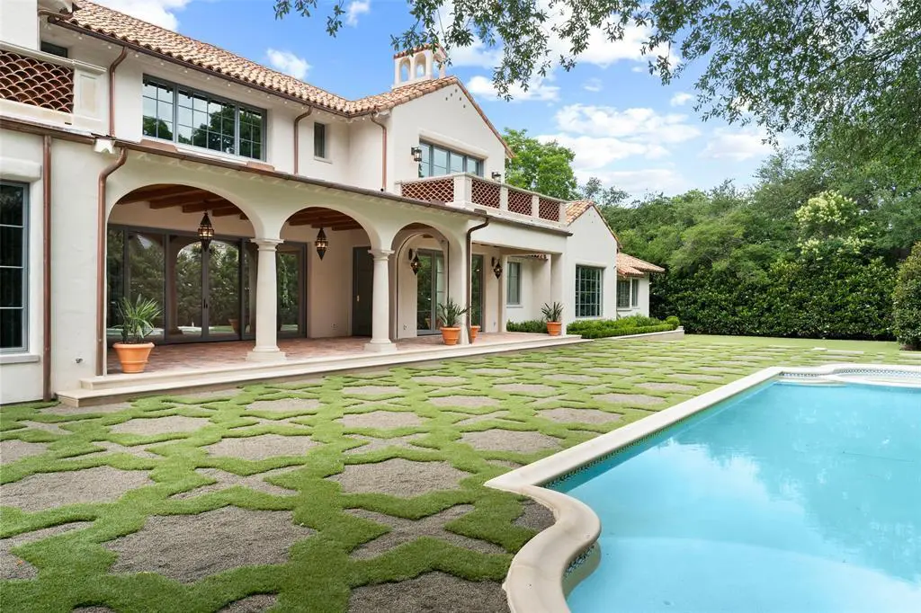 The home sits on nearly one acre of land and features large windows overlooking the pool, lawn, and gardens, accordion glass doors that open to the loggias, and a guest quarters. (Courtesy)