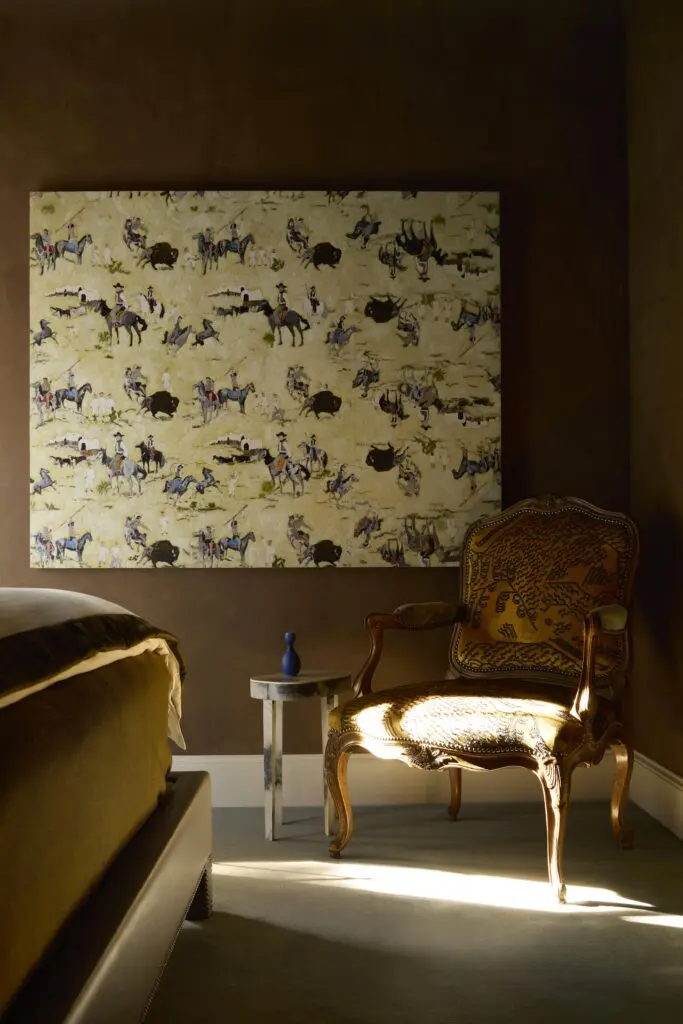In a bedroom, an antique chair from Round Top upholstered in Dedar velvet. Table by John Lytle. Kim Dingle artwork. (Photo by Kristopher Ellis)