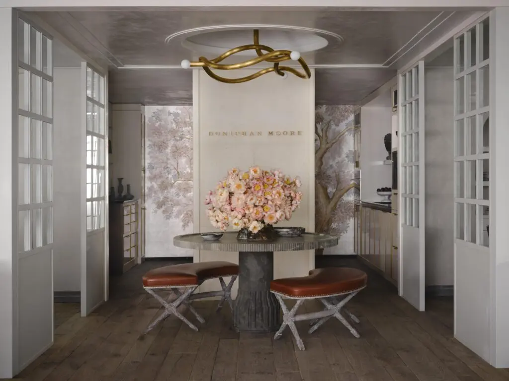 Doniphan Moore designed the center table for his new Uptown studio. Paul Matter chandelier. Steel partitions by Portella. Plaster ceiling and wall detail by Casci Ornamental Plaster. (Photo by Douglas Friedman)