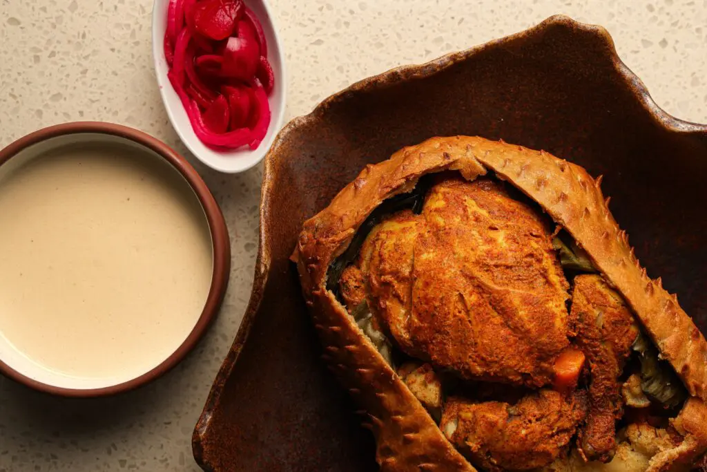 A signature dish of chef Bindra is his whole roasted chicken in a sealed dough crust. (Photo by Chris Furia)