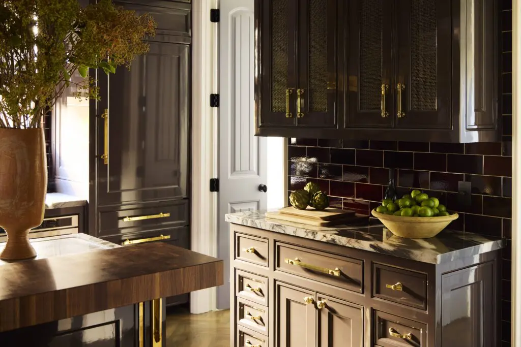 The buffet in the kitchen has Waterworks tile backsplash, and cabinets lacquered in a custom hue from Fine Paints of Europe. (Photo by Kristopher Ellis)