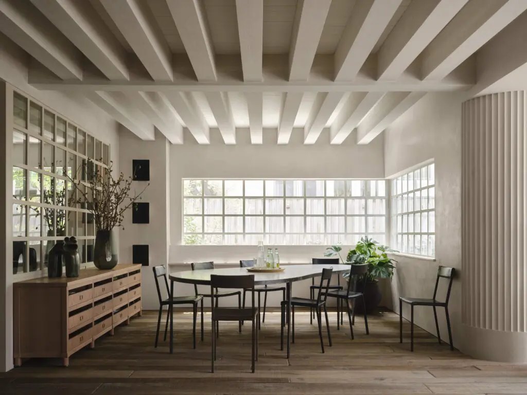 Moore leaned into an industrial Bauhaus idea for the studio with a table and cabinets designed by him. Ochre chairs. Paris Ceramics flooring. Andrew Huges vase. Charlotte Perriand sconces. (Photo by Douglas Friedman)