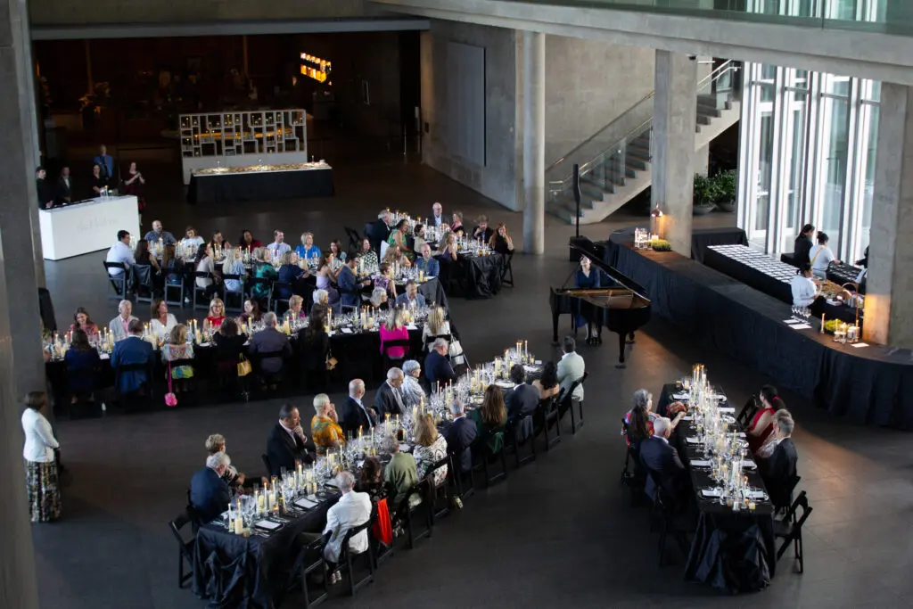 Guests gather beneath the soaring ceilings of The Modern Art Museum for a Champagne-paired dinner and live piano performance. (Courtesy)