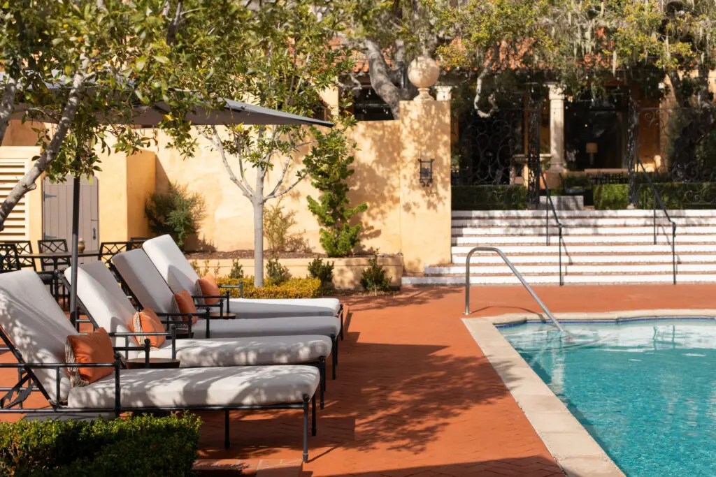 The Mediterranean-style pool shared with the Spa at Pebble Beach invites moments of sun-soaked stillness beneath the trees.