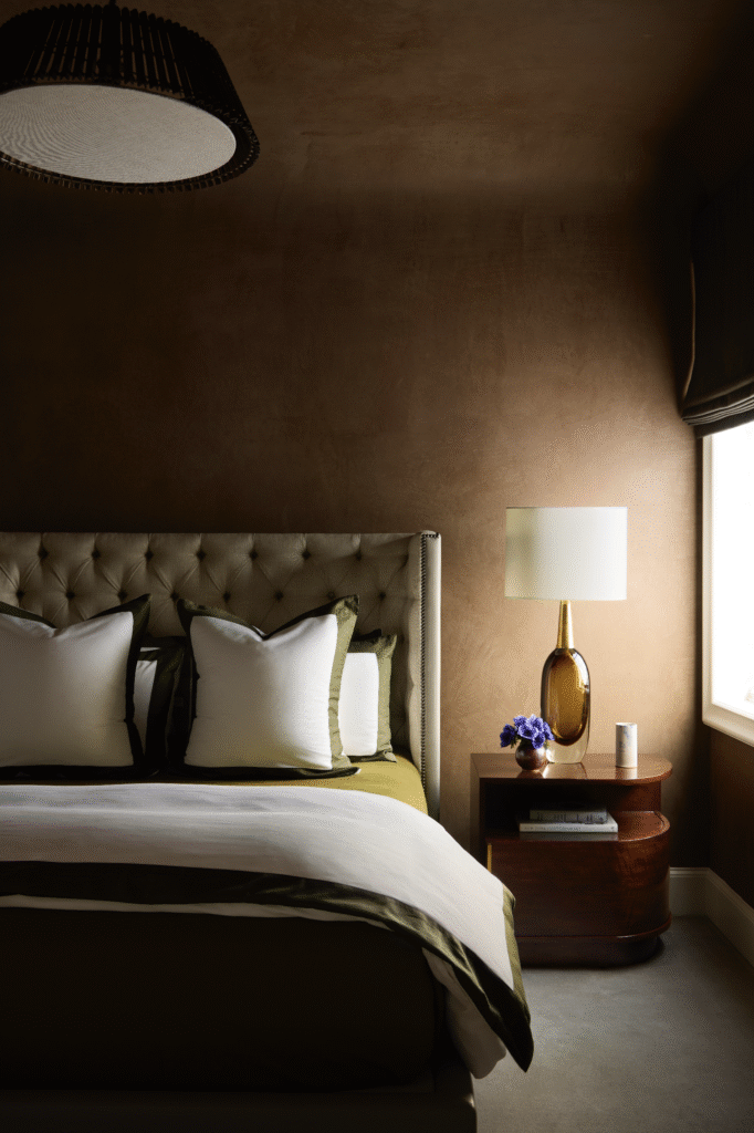 The bed was designed by Moore in Jerry Pair leather and Glant linen. MOUS end table. Seguso Vetri d’Arte lamp from 1stdibs. Porta Romana light fixture. Window covering from The Shade Store. Stark carpet. Plaster-finish walls by Chateau Domingue.  (Photo by Kristopher Ellis)