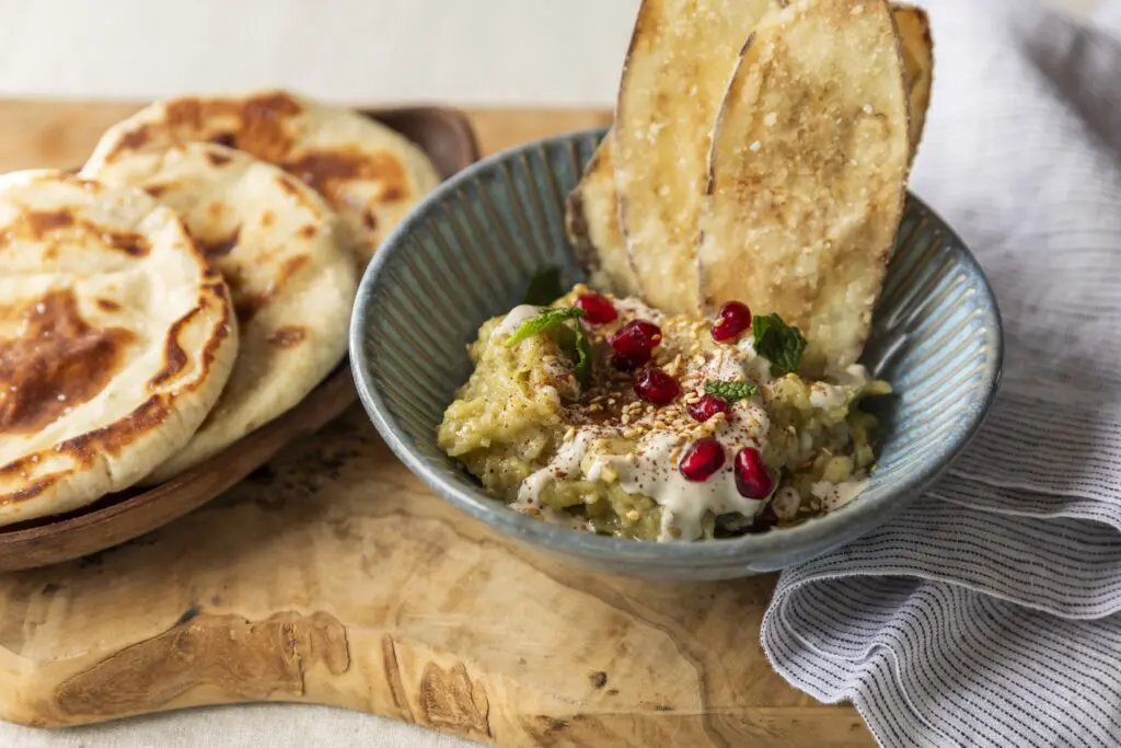 Yiayia’s melitzanosalata, roasted eggplant dip ($14) accented with pomegranate seeds and pita bread. Photo by Julie Soefer.