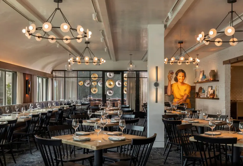 Natural textures like wicker and rattan along with Mediterranean hues of crisp whites and azure blue wash over the new Yiayia restaurant from the oyster bar to the covered outdoor patio. Wide tables are designed to encourage sharing meze and more. (Photo by Claudia Casbarian)