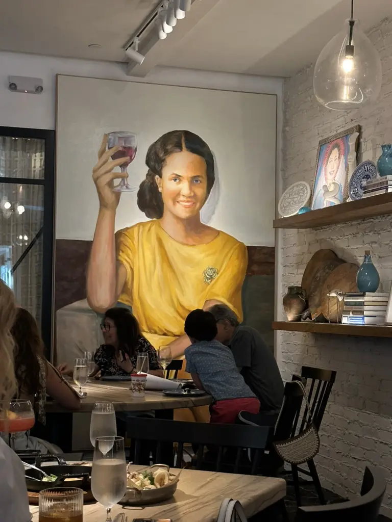 A larger than life painting of Mary Pappas, the family matriarch whose culinary legacy inspires the fare at Yiayia's Greek Restaurant. (Photo by Shelby Hodge)