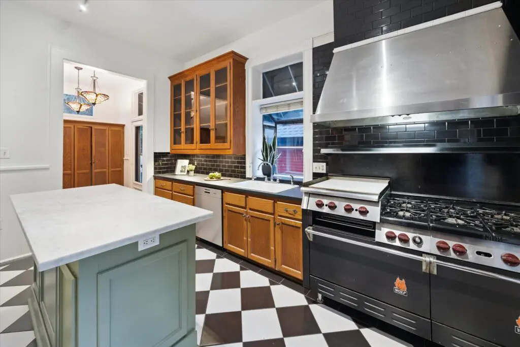 When the home serves as a Bed & Breakfast, the kitchen outfitted with a commercial Wolf stove with double ovens. (Photo by TK Images)