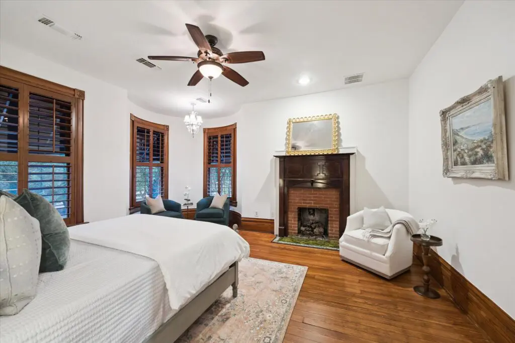 The bedroom has one of the two fireplaces in the home at 1011 Heights Blvd. (Photo by TK Images)