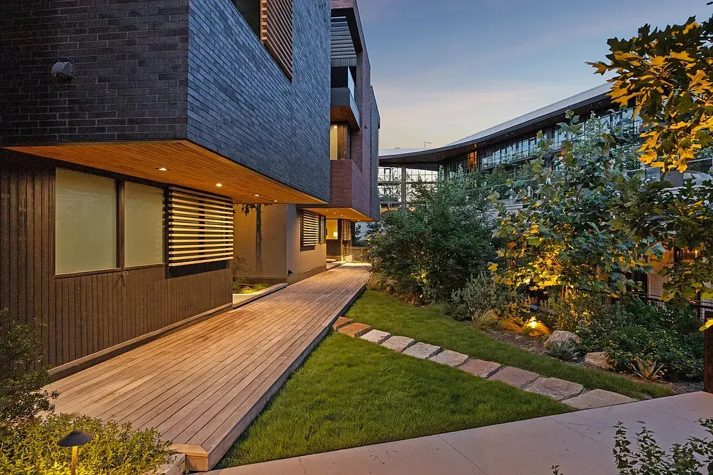 Landscaped walkways connect the private residences to Bowie House, blending greenery with contemporary design. (Courtesy)