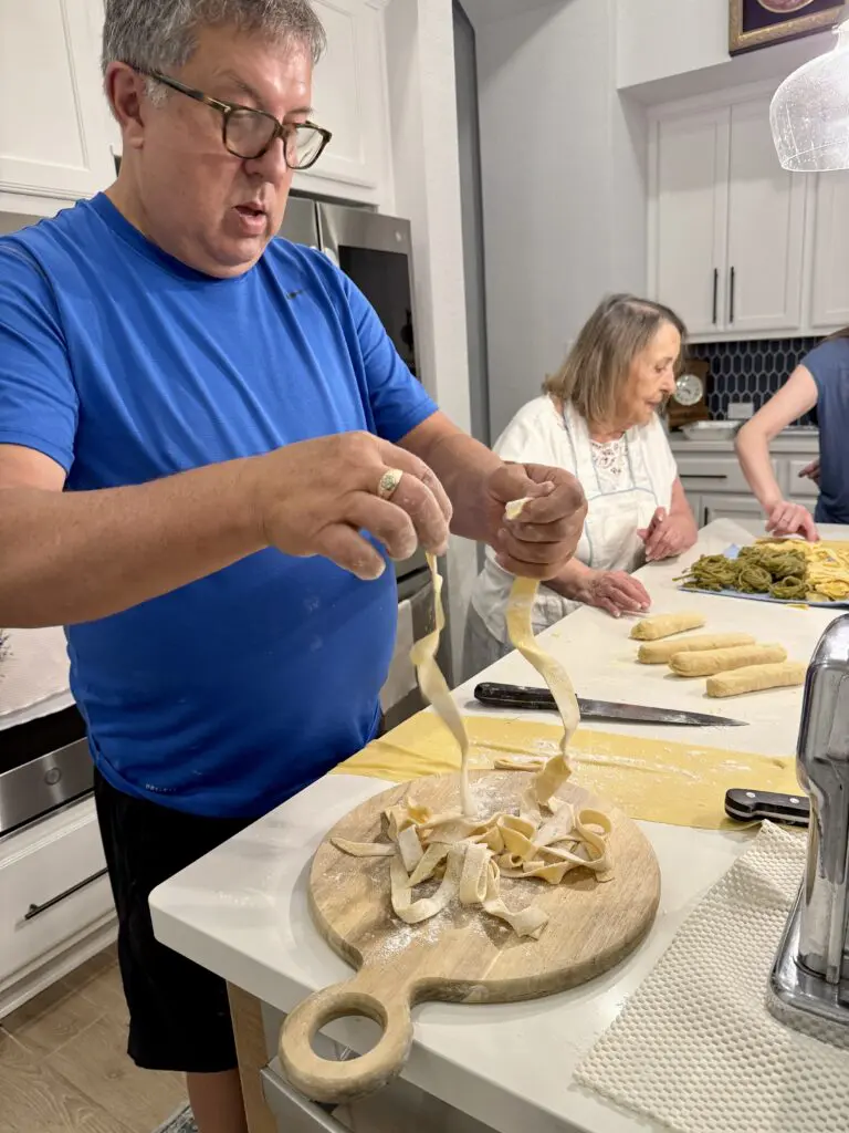 Elda and her son Carlos at home in Nonna's kitchen working with pasta dough. (Photo by Sherri Segari)