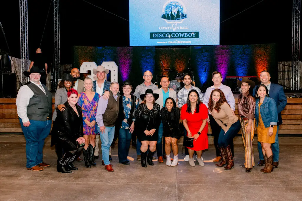 Supporters gathered on stage at last year’s Cowtown Ball, a night that mixed Western style, community spirit, and fundraising power for the American Cancer Society.