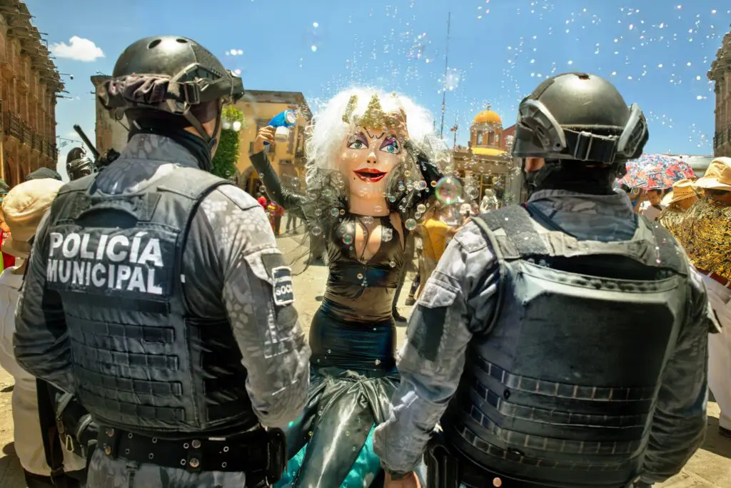 Laura Wilson's "Municipal Police with Bubble Lady, Los Locos Parade, Parroquia, San Miguel de Allende, Guanajuato," 2024, at Meadows Museum, SMU (© Laura Wilson)