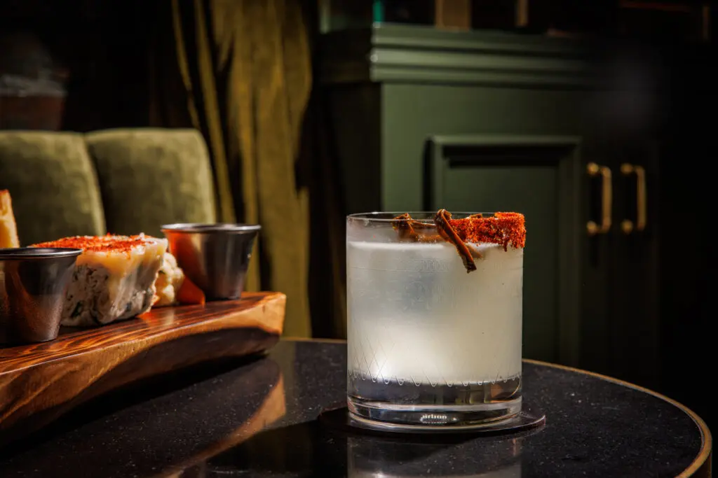 For spice lovers, Caché's Holy Trinity is made with mezcal, poblano liqueur, and bell pepper oleo. (Photo by Samantha Marie Photography)