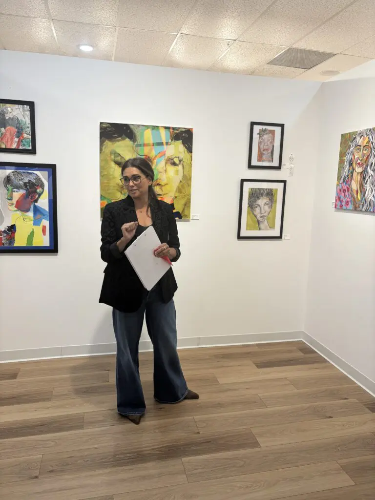 Guest juror Gabriella Monterroso stands with Phyllis Love’s work "Just for Fun." (Photo by Laura Landsbaum)