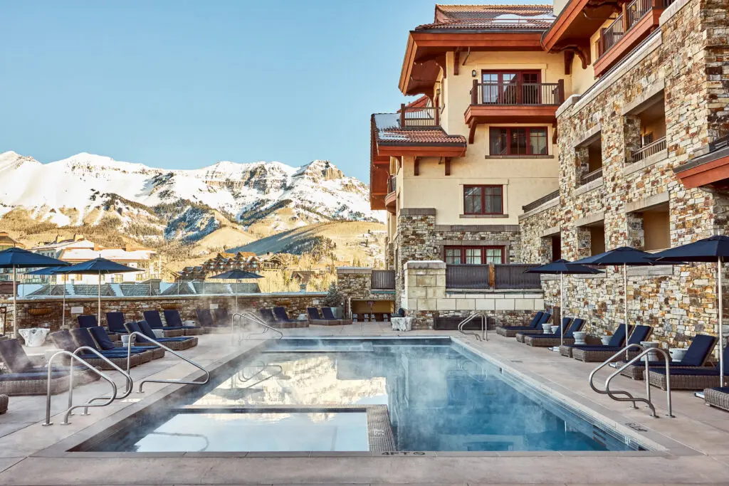 The Alpine Swim Club’s heated pool offers year-round mountain views worth lingering over. (Photo by Auberge Collection)
