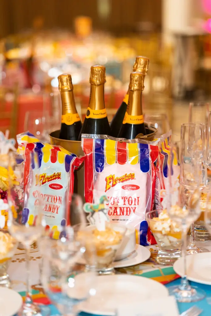 Guests found bags of popcorn and cotton candy at their table; Some wasted no time popping a bit of pink cotton candy into their champagne flutes. (Photo by Sharon Ellman)