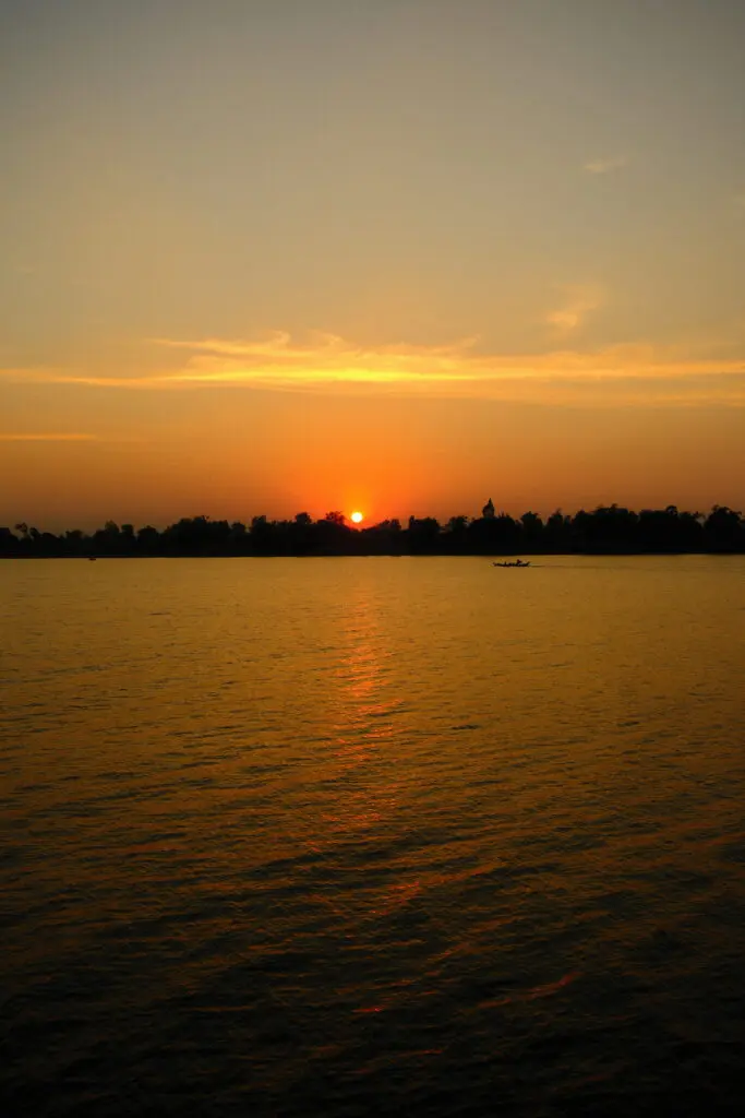 Sundowner cocktails on quiet stretches of riverbank are a ritual of the Aqua Mekong expedition. (photo by Georgie Miller)