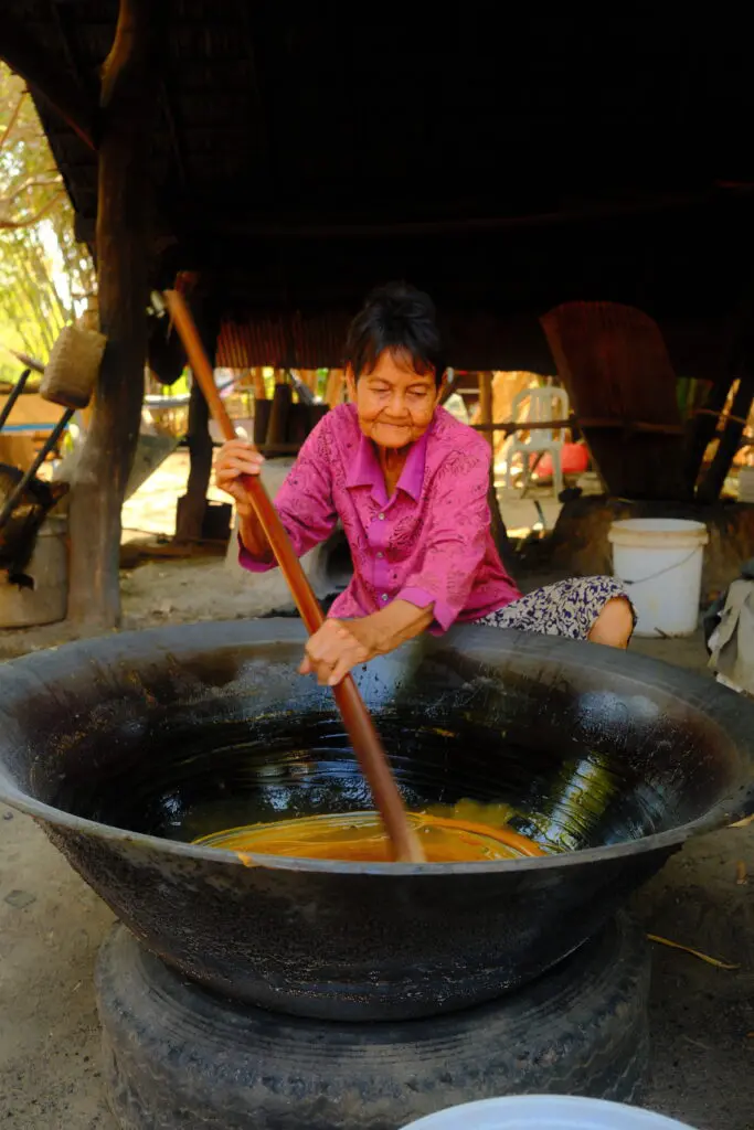 Palm sugar harvesters scale tall palms to collect sap, then stir it over an open flame for hours along the banks of the Tonle Sap. (photo by Georgie Miller)