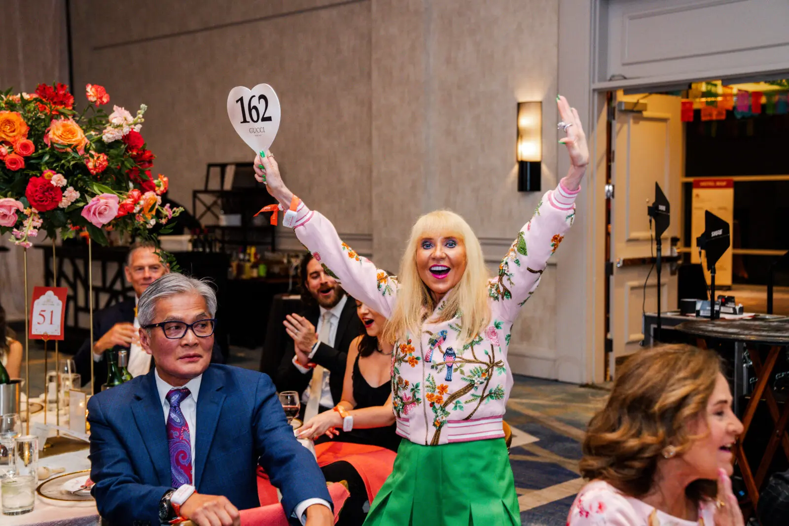 Alison Ye celebrates her auction win at Habitat for Humanity's gala at The Woodlands Waterway Marriott. (Photo by Alex Cross Photography)